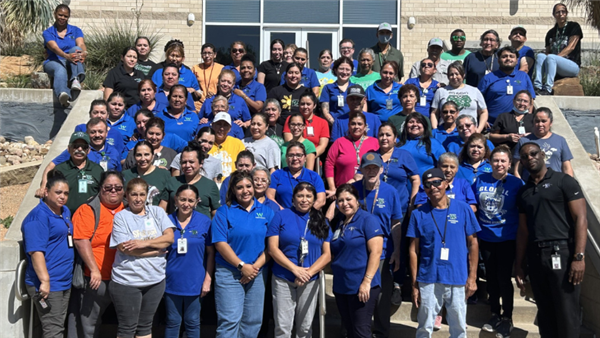 large group of employees outside on steps